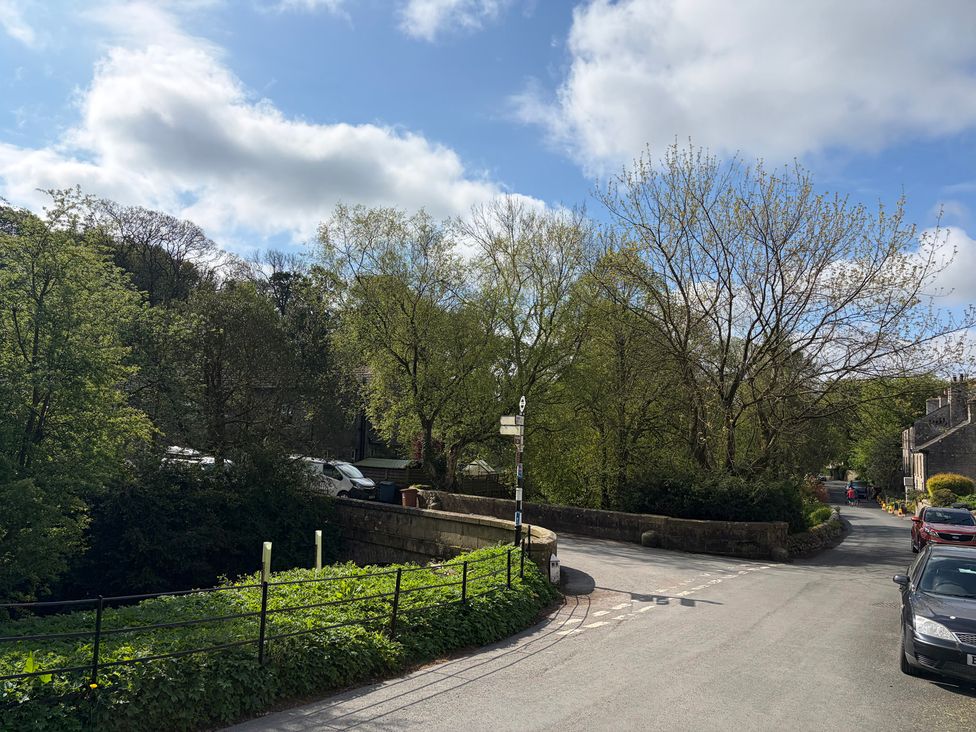 A view of a street with trees and cars at Cross Winds in Clapham