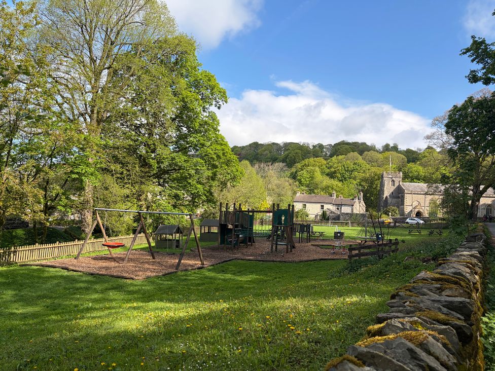 A playground with swings and climbing frame at Cross Winds in Clapham
