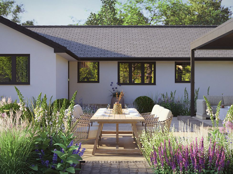 A garden with a table and chairs at Cross Winds in Clapham