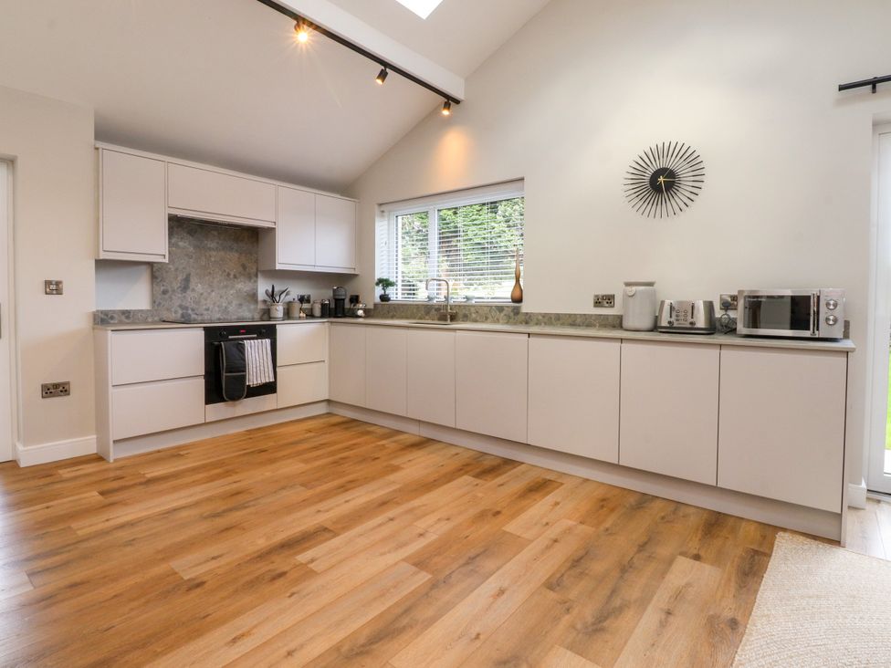 A kitchen with cabinets and appliances at Cross Winds in Clapham