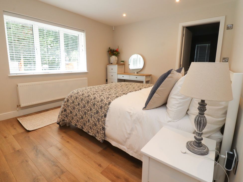A bedroom with a bed and a dresser at Cross Winds in Clapham