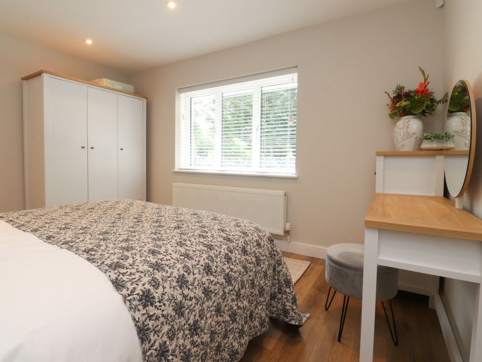 A bedroom with a bed and wardrobe at Cross Winds in Clapham