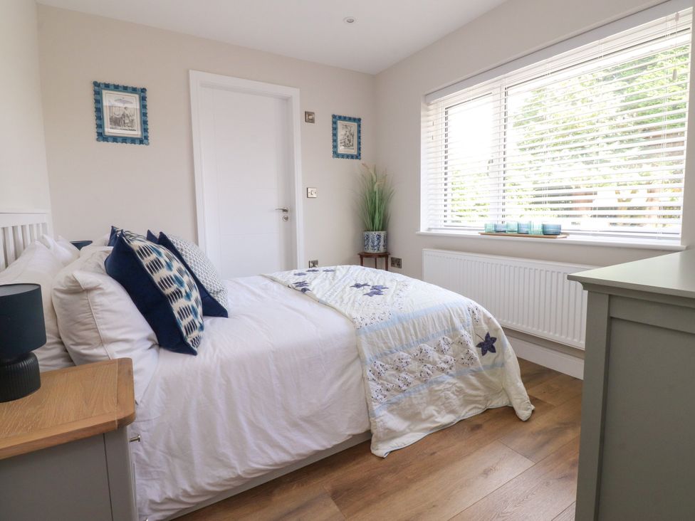 A bedroom with a bed and window at Cross Winds in Clapham