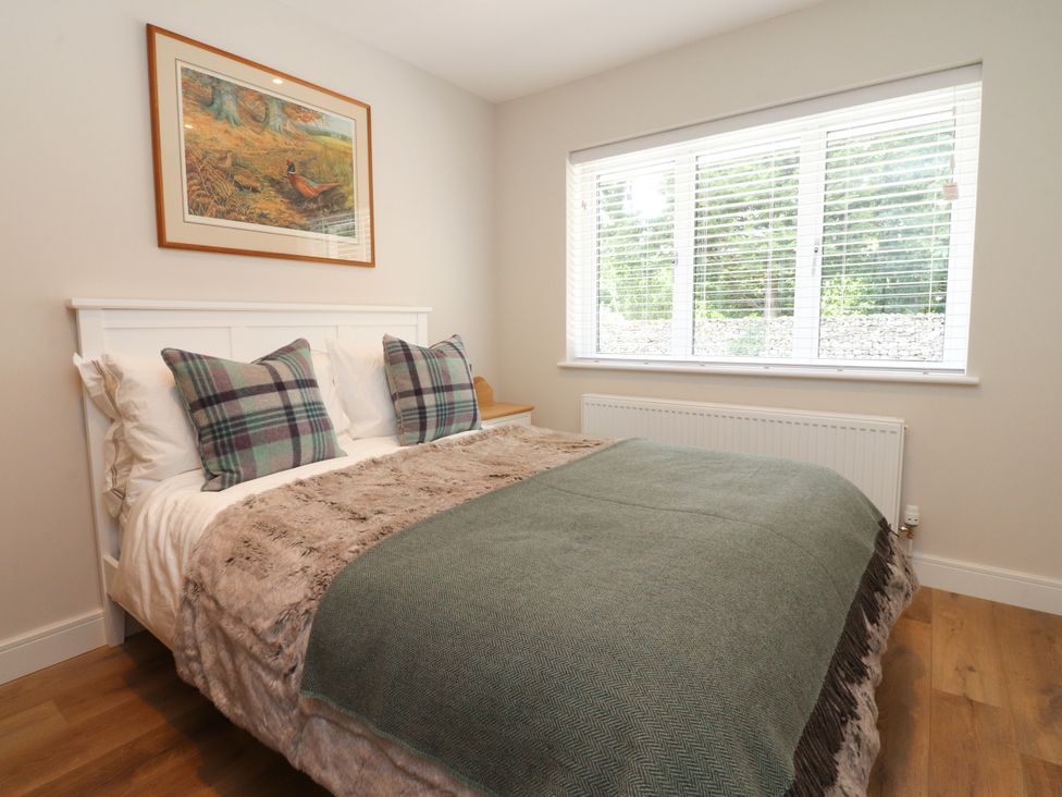 A bedroom with a bed and window at Cross Winds in Clapham