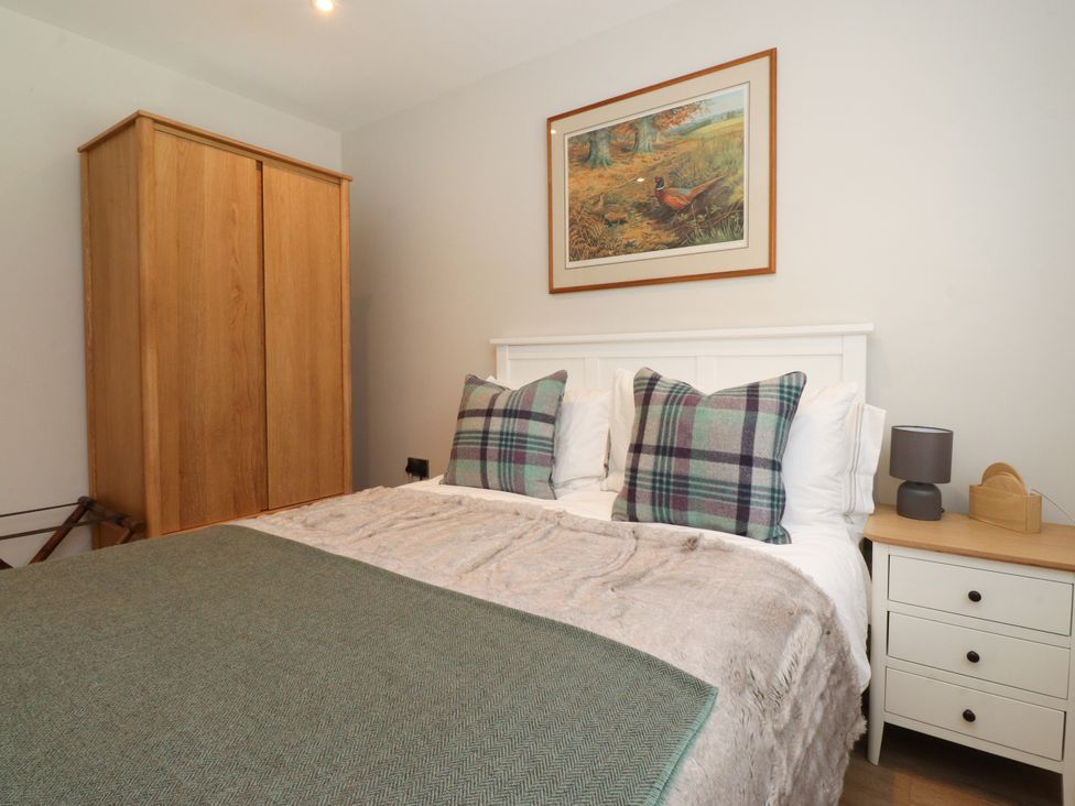 A bedroom with a bed and wardrobe at Cross Winds in Clapham