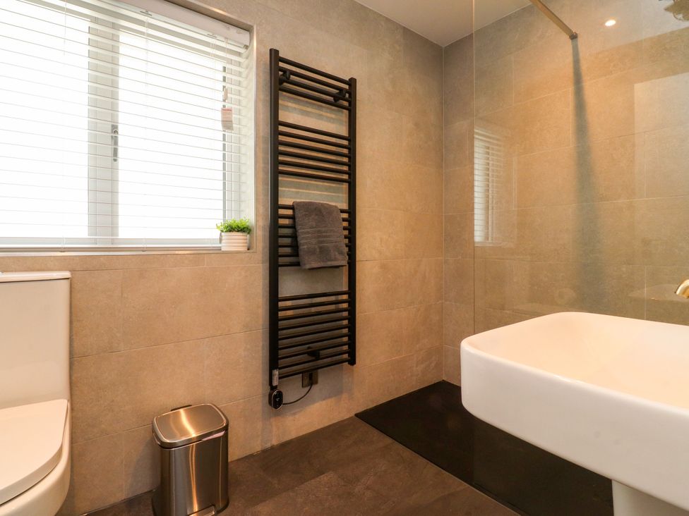 A bathroom with a sink and towel warmer at Cross Winds in Clapham