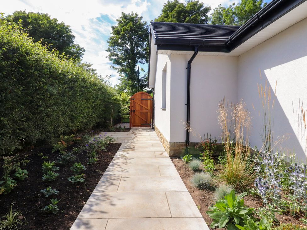 A garden pathway leading to a wooden gate at Cross Winds in Clapham