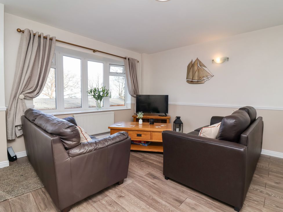 A living room with two sofas and a television at Castle View Lodge in Ilfracombe
