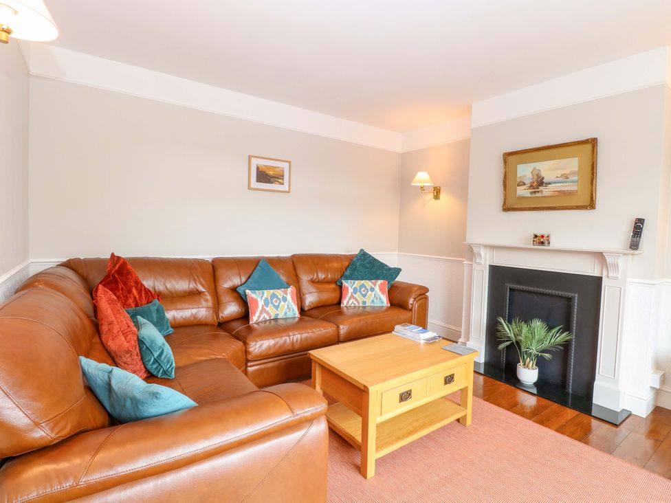 A living room with a sofa and coffee table at Highland House in Sheringham