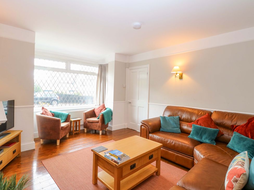 A living room with a sofa and armchairs at Highland House in Sheringham