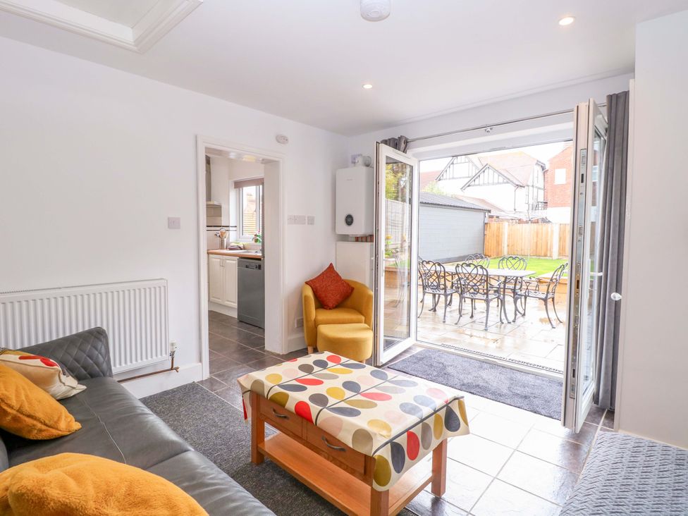 A living room with a sofa and coffee table at Highland House in Sheringham
