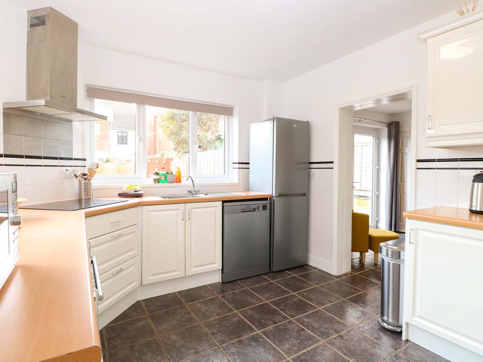 A kitchen with appliances and a countertop at Highland House in Sheringham