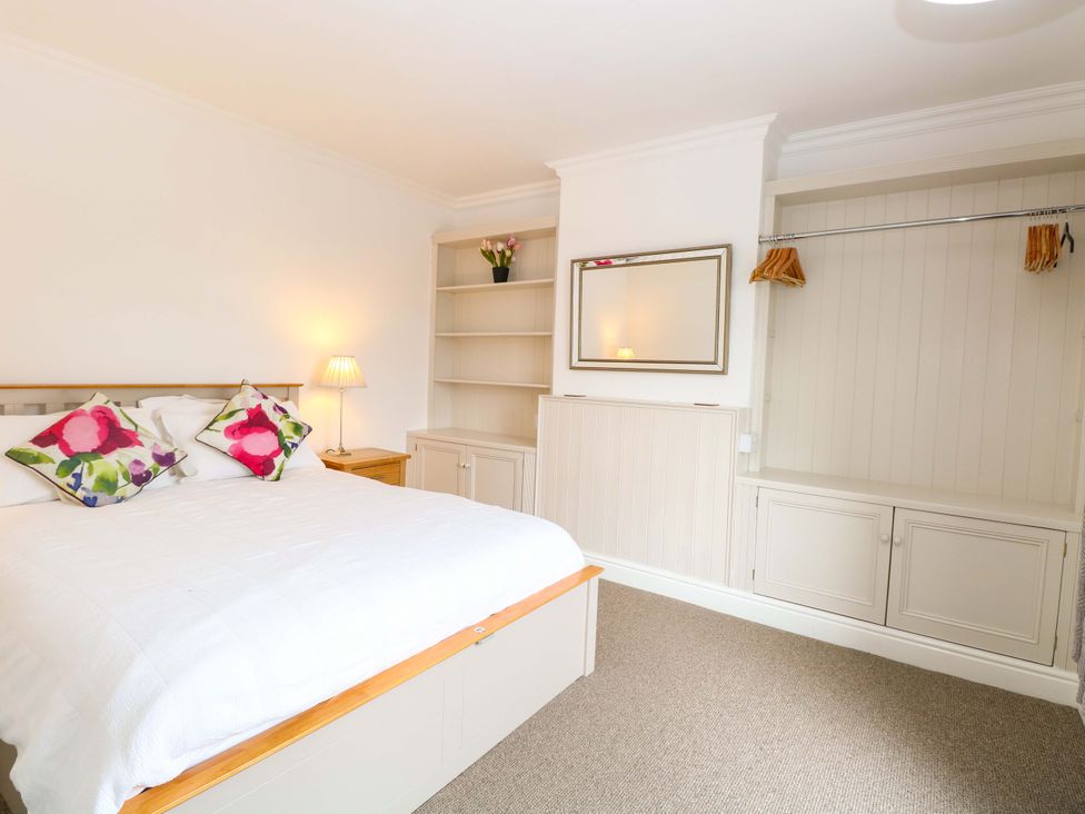 A bedroom with a bed and shelf at Highland House in Sheringham