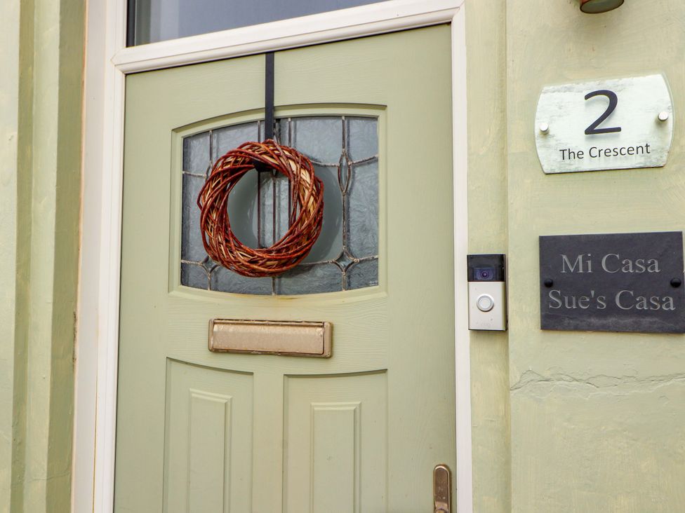A front door with a wreath and name plaque at 2 The Crescent