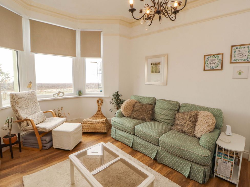A living room with a sofa and armchair at 2 The Crescent