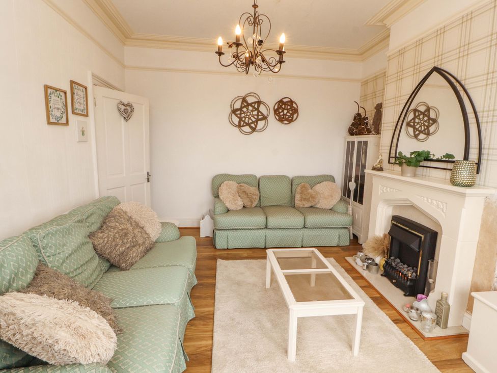 A living room with a coffee table and sofa at 2 The Crescent