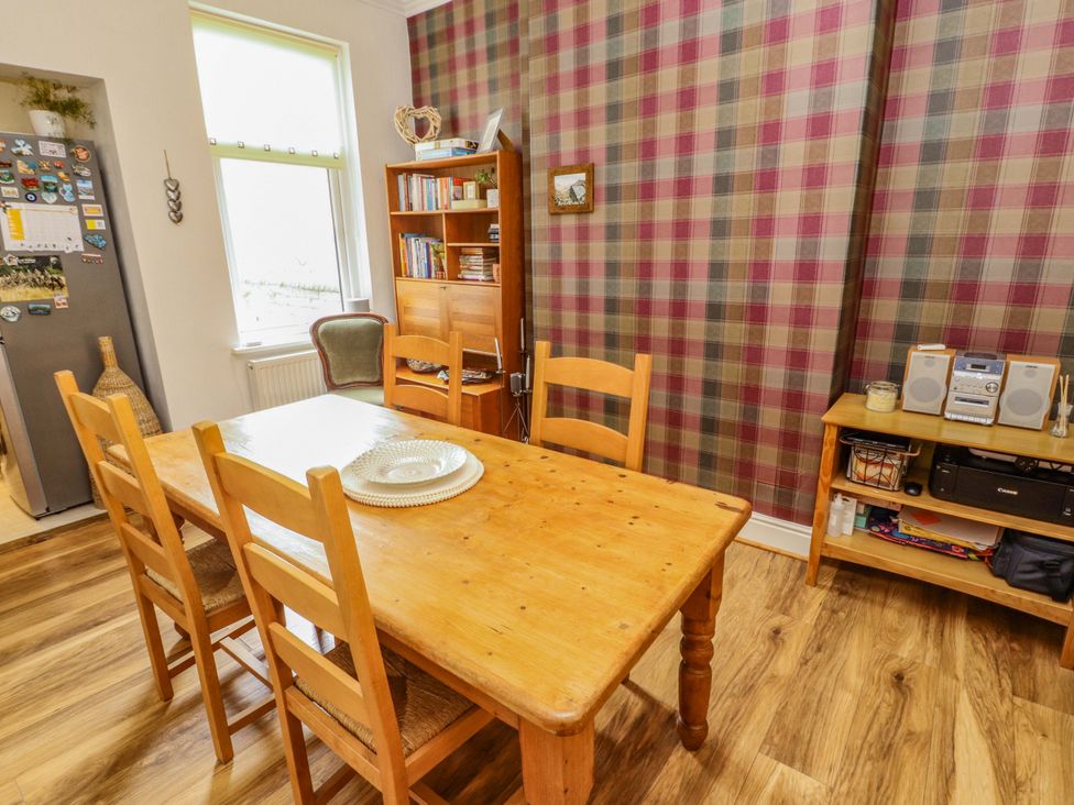 A dining room with a table and chairs at 2 The Crescent