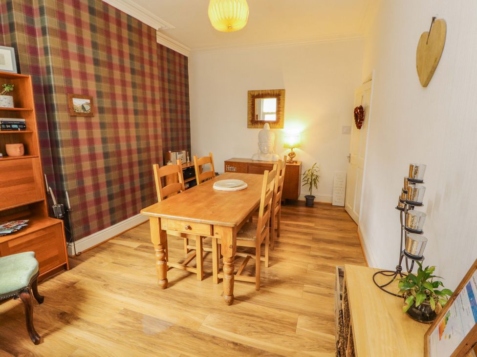 A dining room with a wooden table and chairs at 2 The Crescent