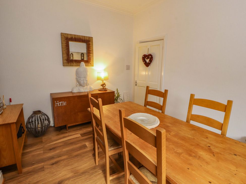 A dining room with a table and chairs at 2 The Crescent