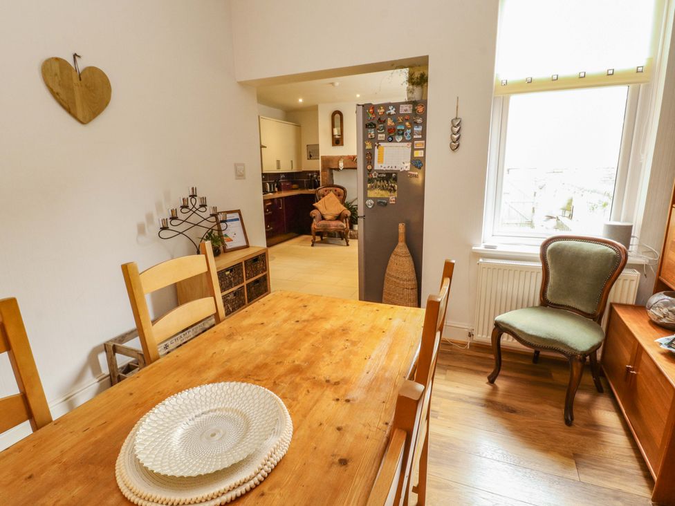 A dining room with a wooden table and chairs at 2 The Crescent