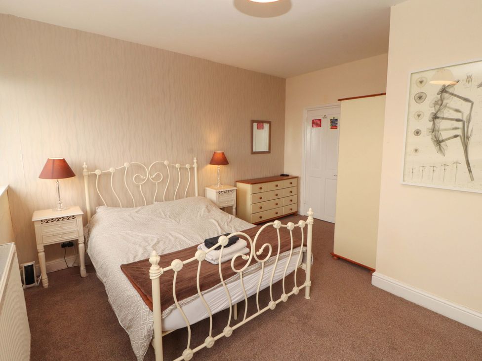 A bedroom with a bed and dresser at 2 The Crescent