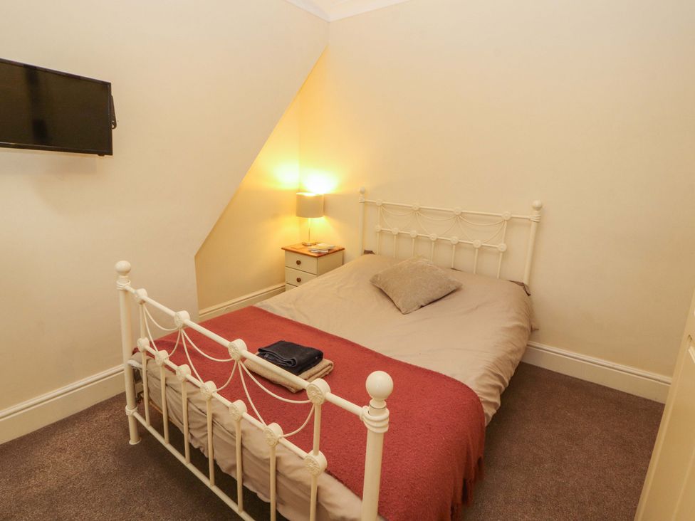 A bedroom with a bed and bedside table at 2 The Crescent
