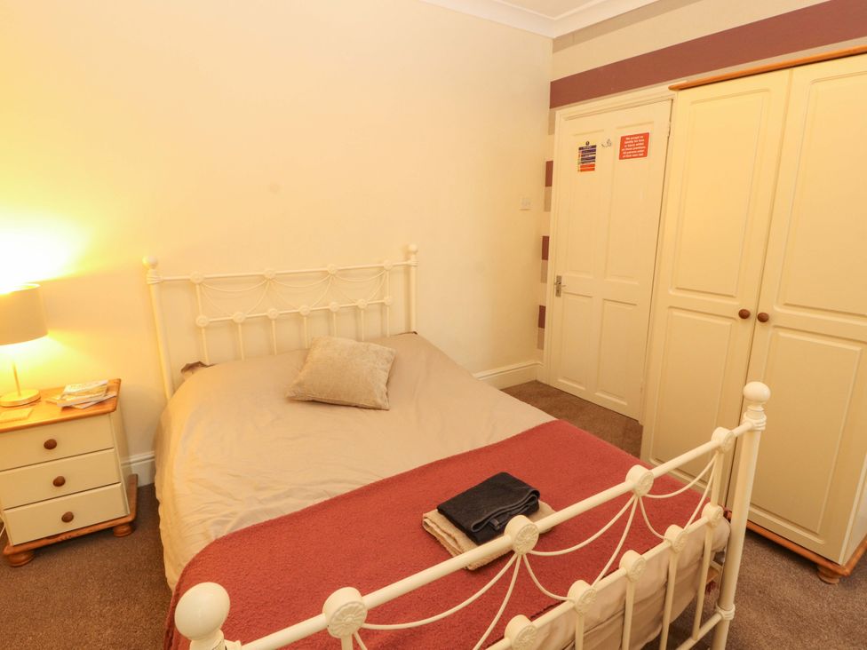 A bedroom with a bed and wardrobe at 2 The Crescent