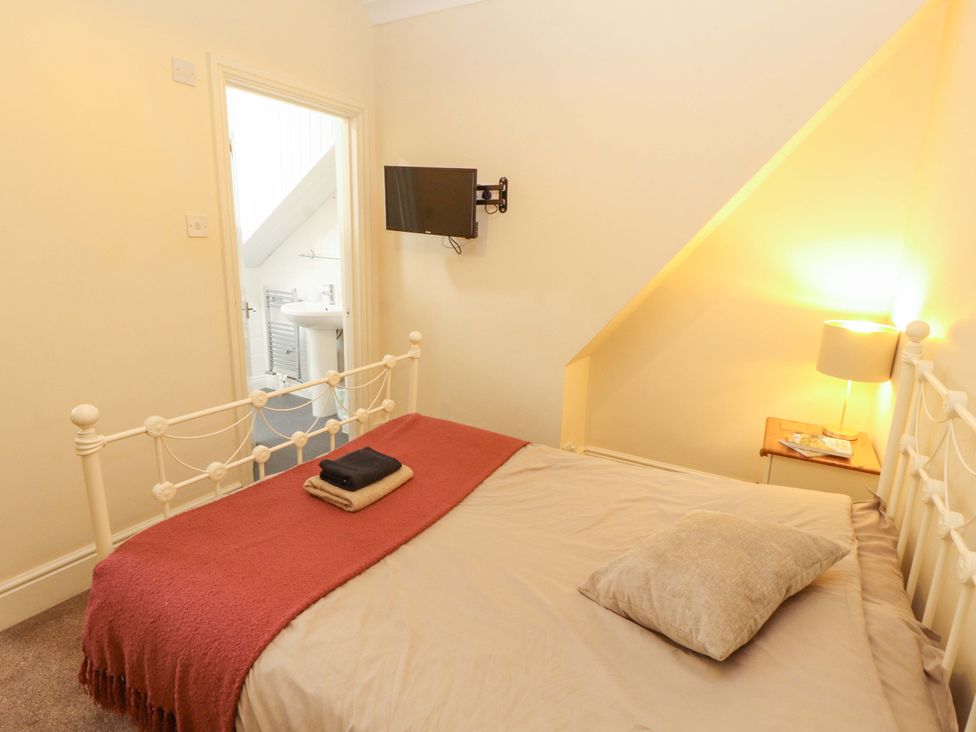 A bedroom with a bed and TV at 2 The Crescent