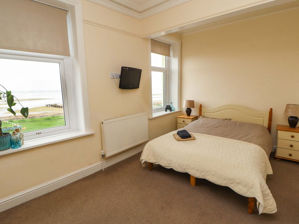 A bedroom with a bed and television at 2 The Crescent