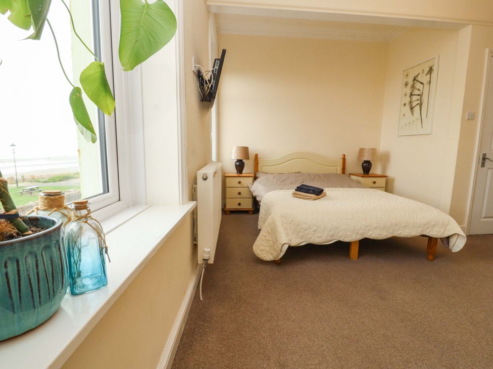 A bedroom with a bed and nightstands at 2 The Crescent