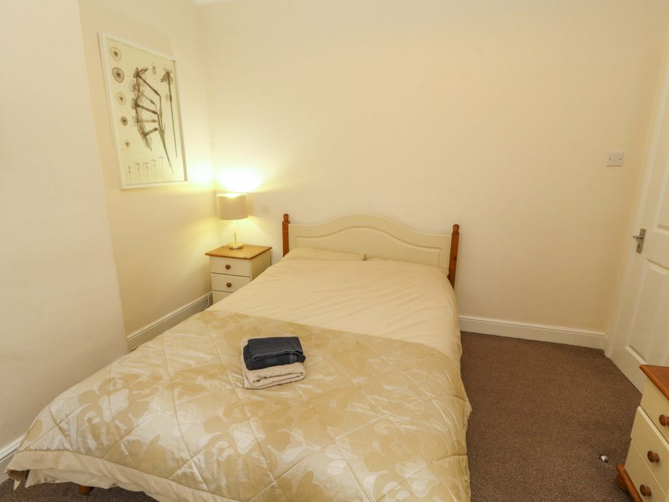 A bedroom with a bed and lamp at 2 The Crescent 
