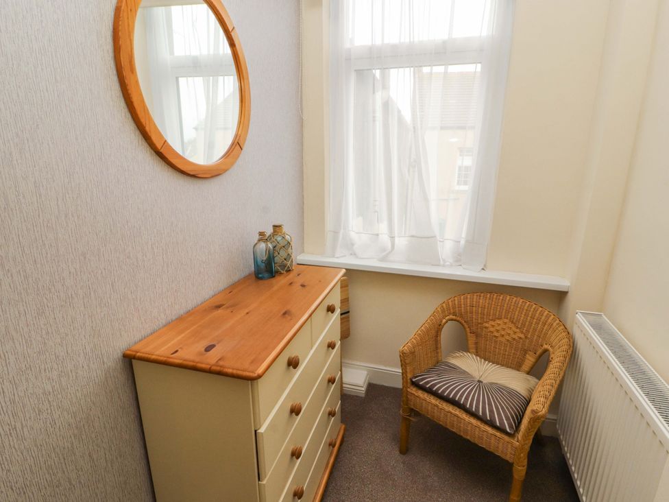 A corner with a dresser and a chair at 2 The Crescent 