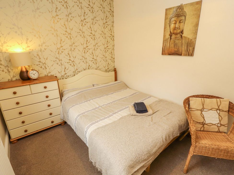 A bedroom with a bed and dresser at 2 The Crescent