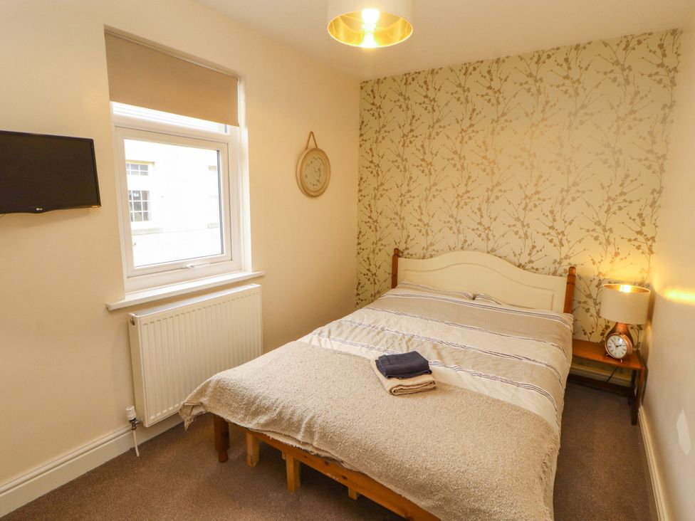 A bedroom with a bed and television at 2 The Crescent