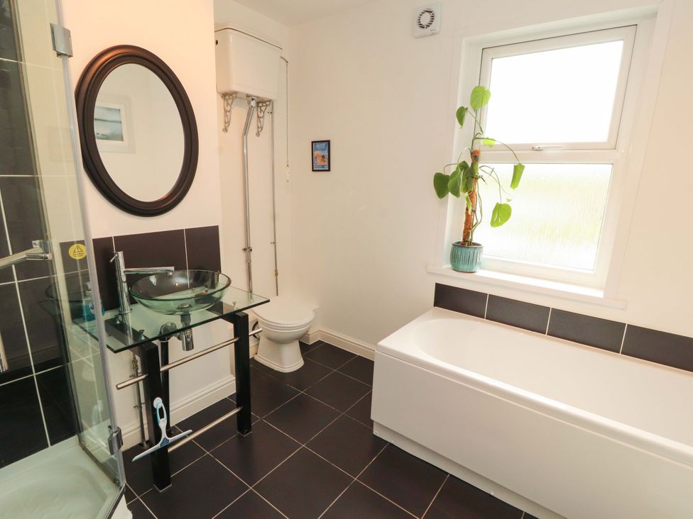 A bathroom with a sink, toilet, bathtub and shower at 2 The Crescent