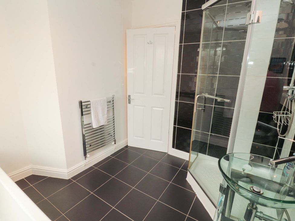 A bathroom with a shower and towel radiator at 2 The Crescent