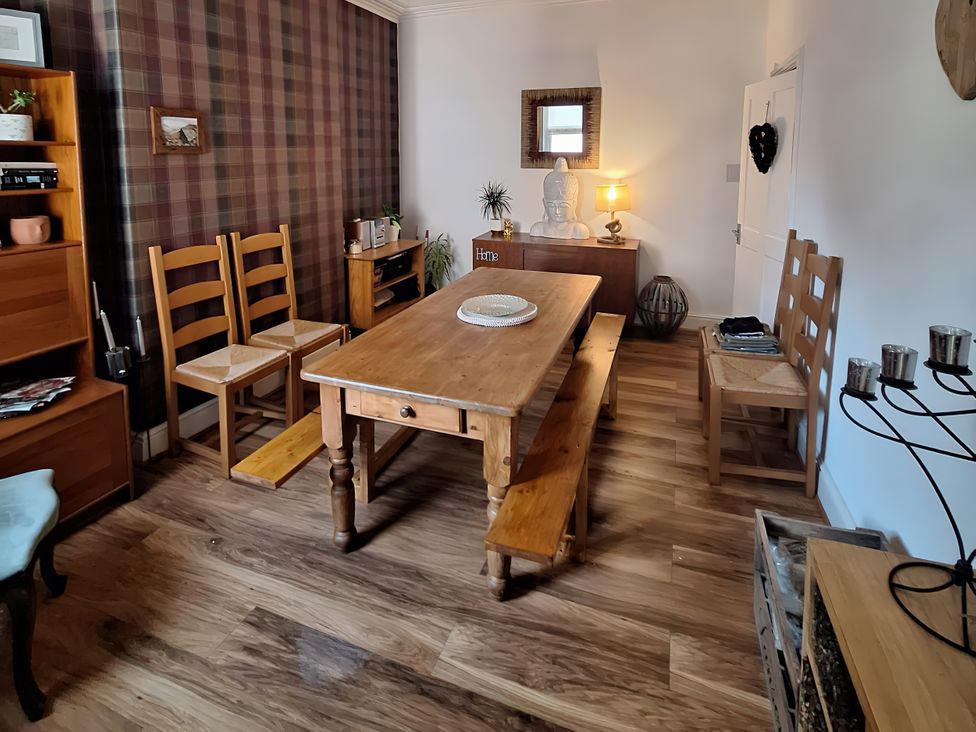 A dining room with a wooden table and chairs at 2 The Crescent, Seascale