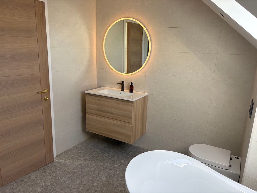 A bathroom with a sink and a bathtub at Seaddler in Trearddur Bay