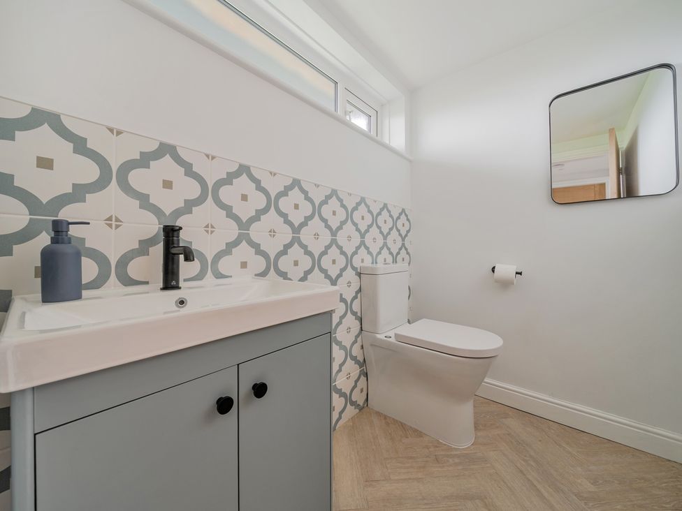 A bathroom with a sink and toilet at Seaddler Trearddur Bay