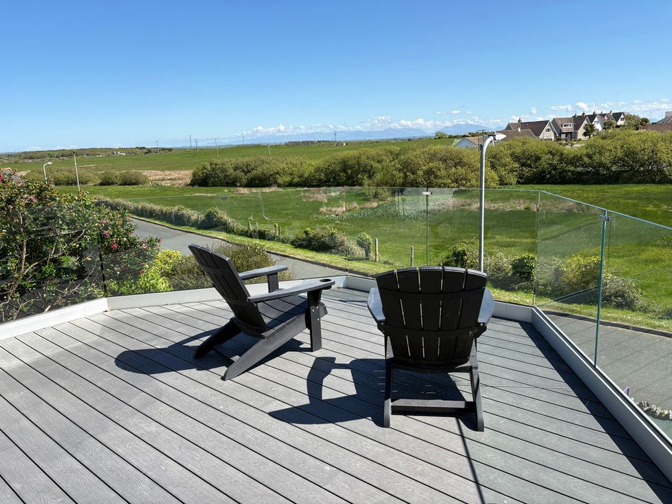 An outdoor area with chairs and a view at Seaddler in Trearddur Bay