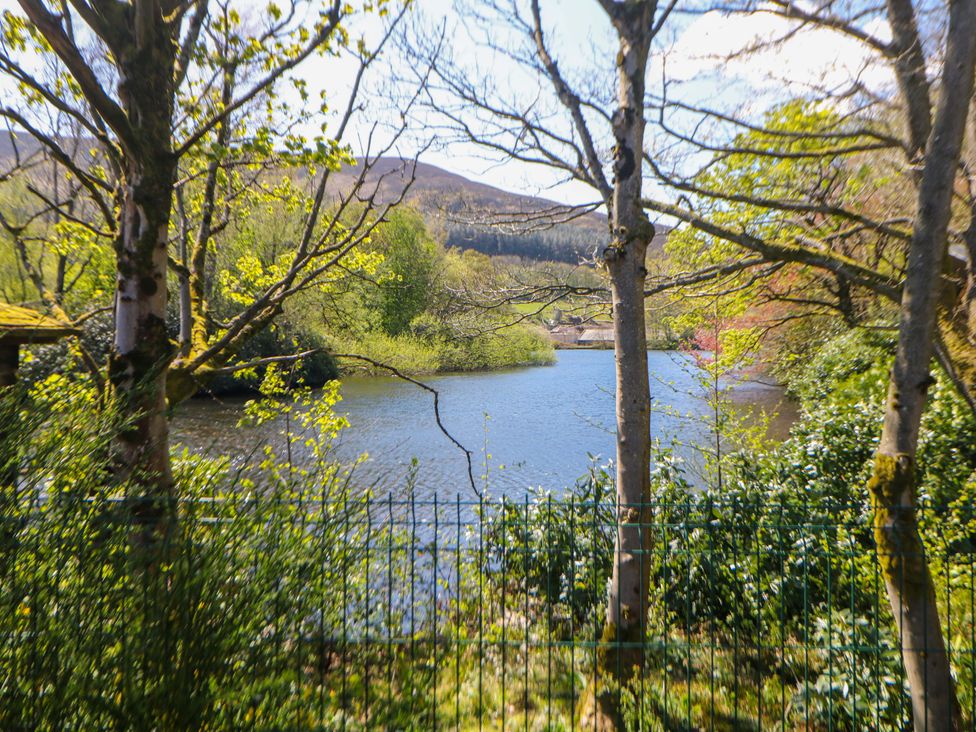 A view of a river surrounded by trees and bushes at Dovestone Luxury Lodges (sleeps 4)- pet free, Greenfield