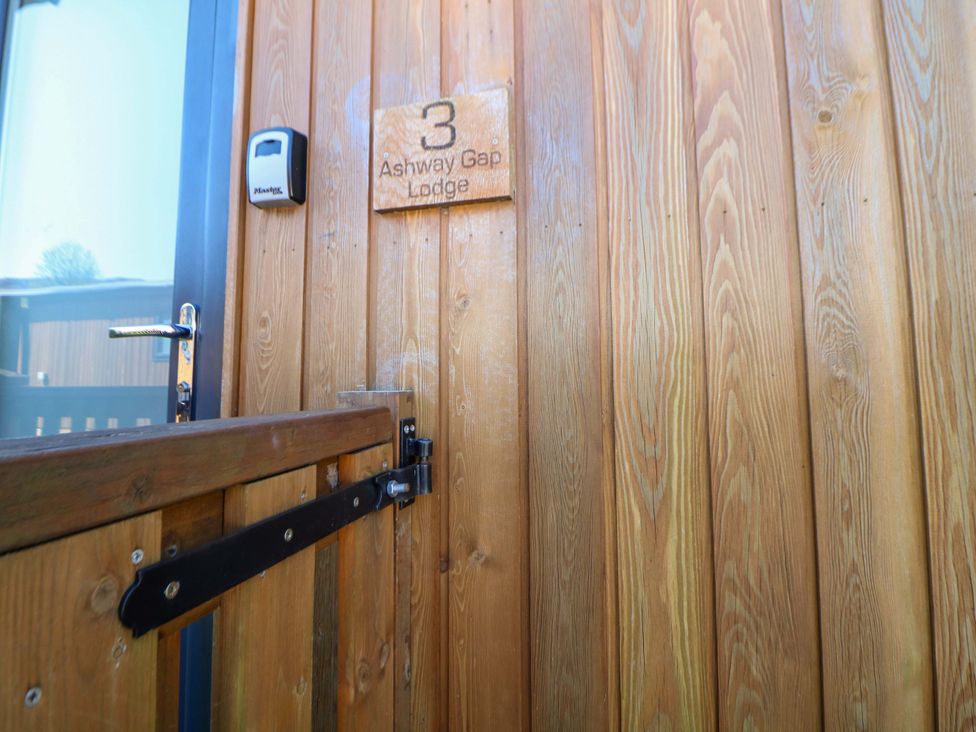 An entrance door with wooden paneling at Ashway Gap Lodge in Greenfield