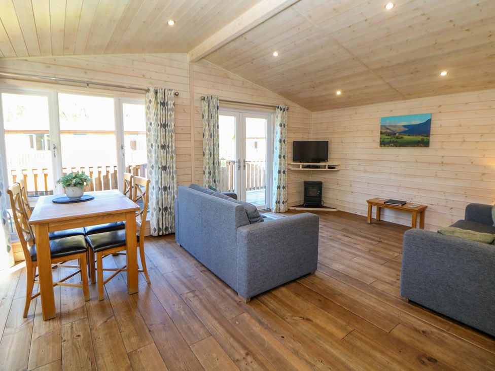 A living room with a dining table and sofa at Dovestone Luxury Lodges (sleeps 4) - pets welcome, Greenfield