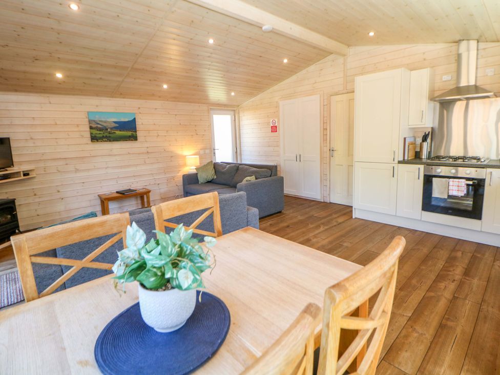 A living room with a sofa and dining table at Dovestone Luxury Lodges (sleeps 4) - pets welcome, Greenfield