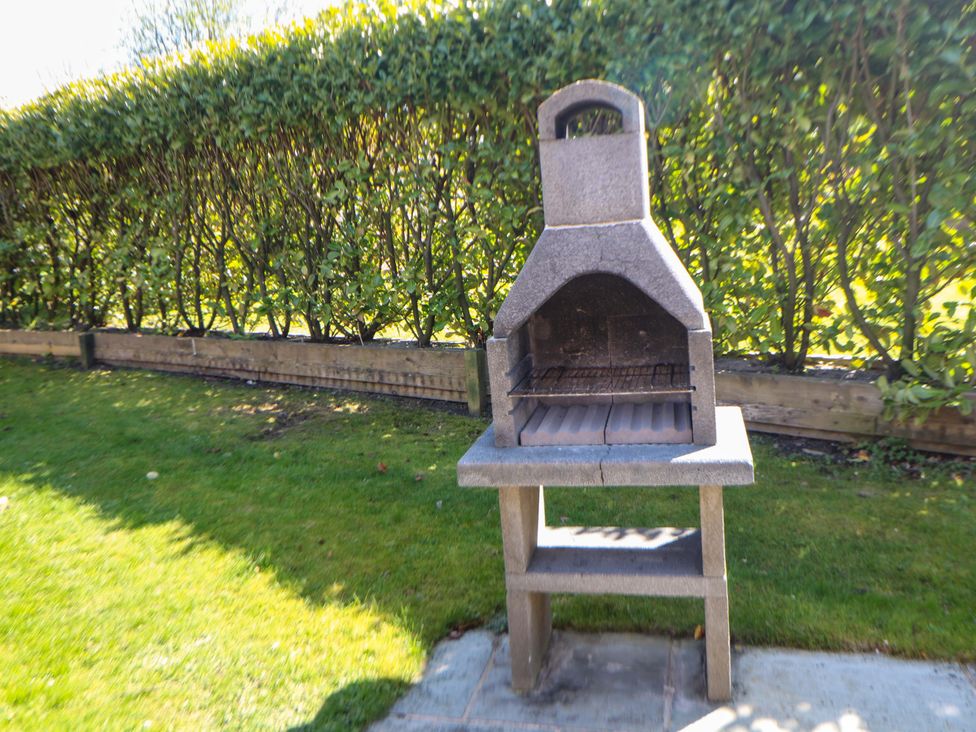 A barbecue grill in a garden at Dovestone Luxury Lodges (sleeps 4) - pets welcome, Greenfield