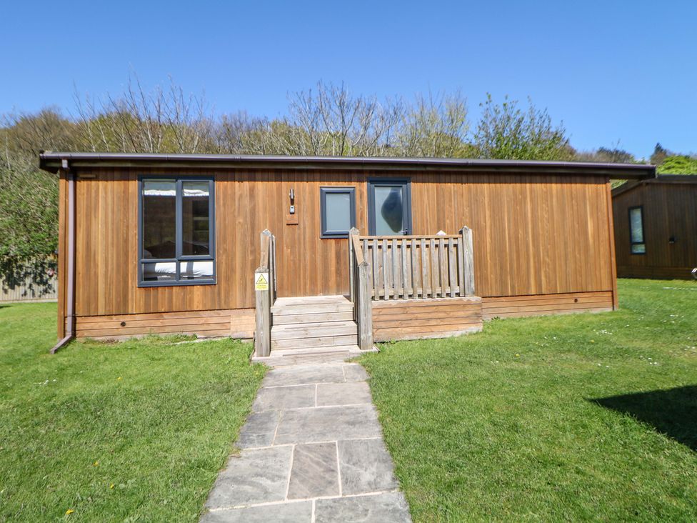 A wooden cabin with steps and a path in front at Dovestone Luxury Lodges (sleeps 6) - pet free, Greenfield