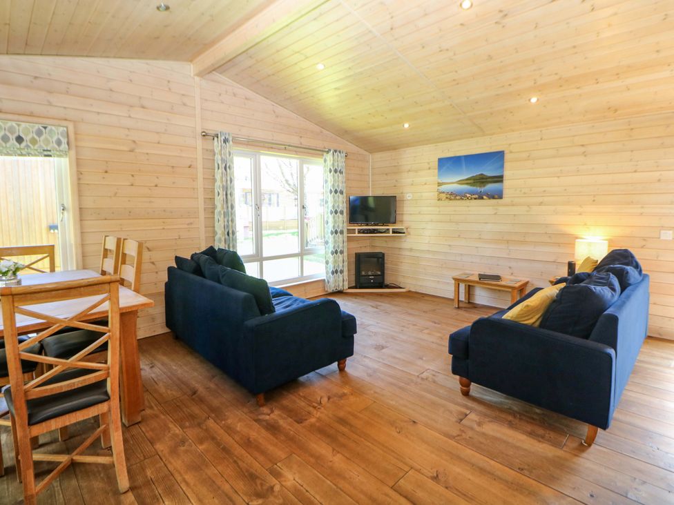 A living room with sofas and a dining table at Dovestone Luxury Lodges (sleeps 6) - pet free in Greenfield