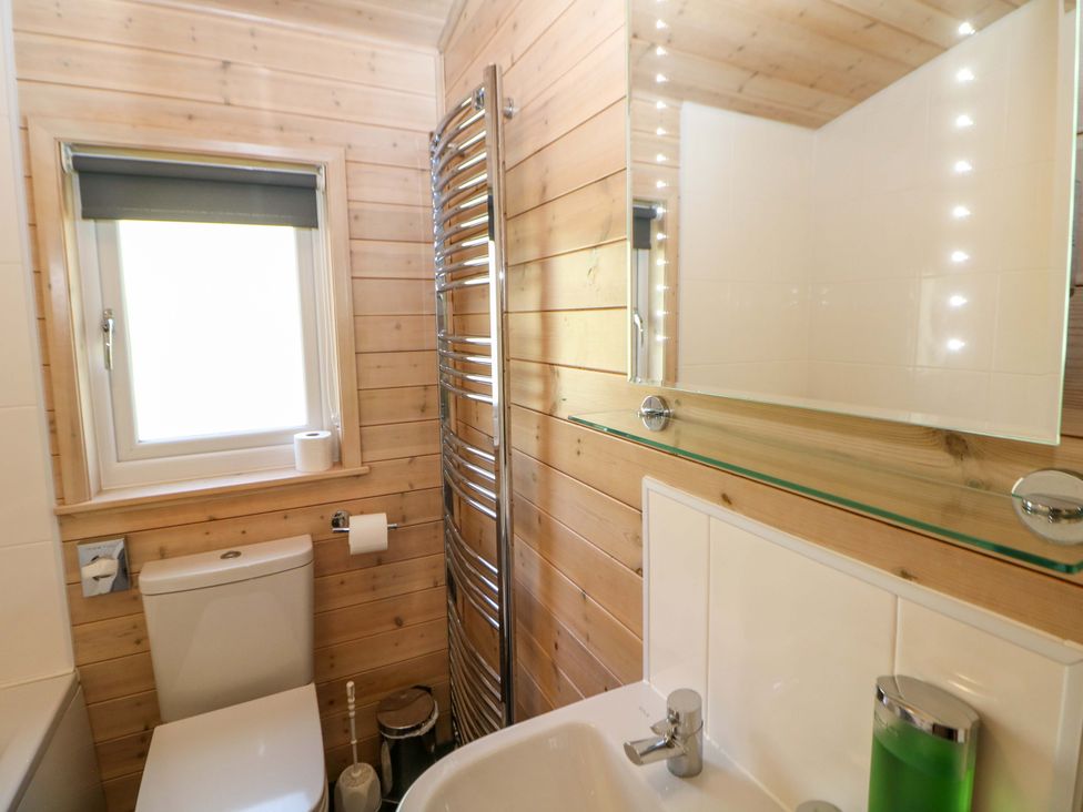 A bathroom with a toilet, sink, and towel rail at Dovestone Luxury Lodges (sleeps 6) - pet free, Greenfield