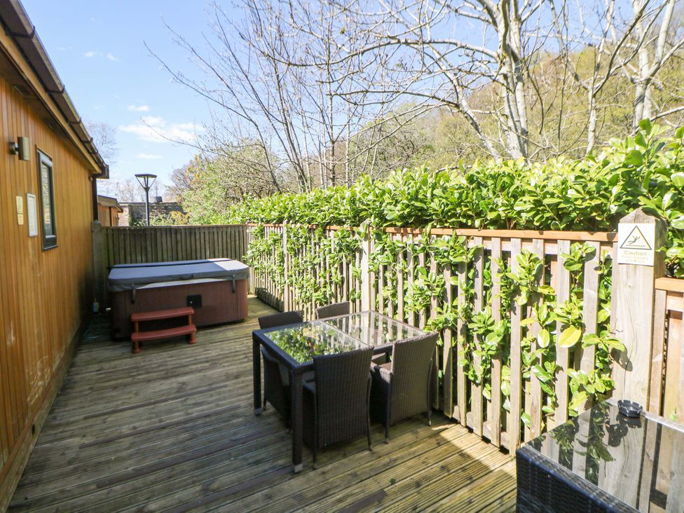 An outdoor area with a hot tub and furniture at Dovestone Luxury Lodges (sleeps 6) - pet free, Greenfield