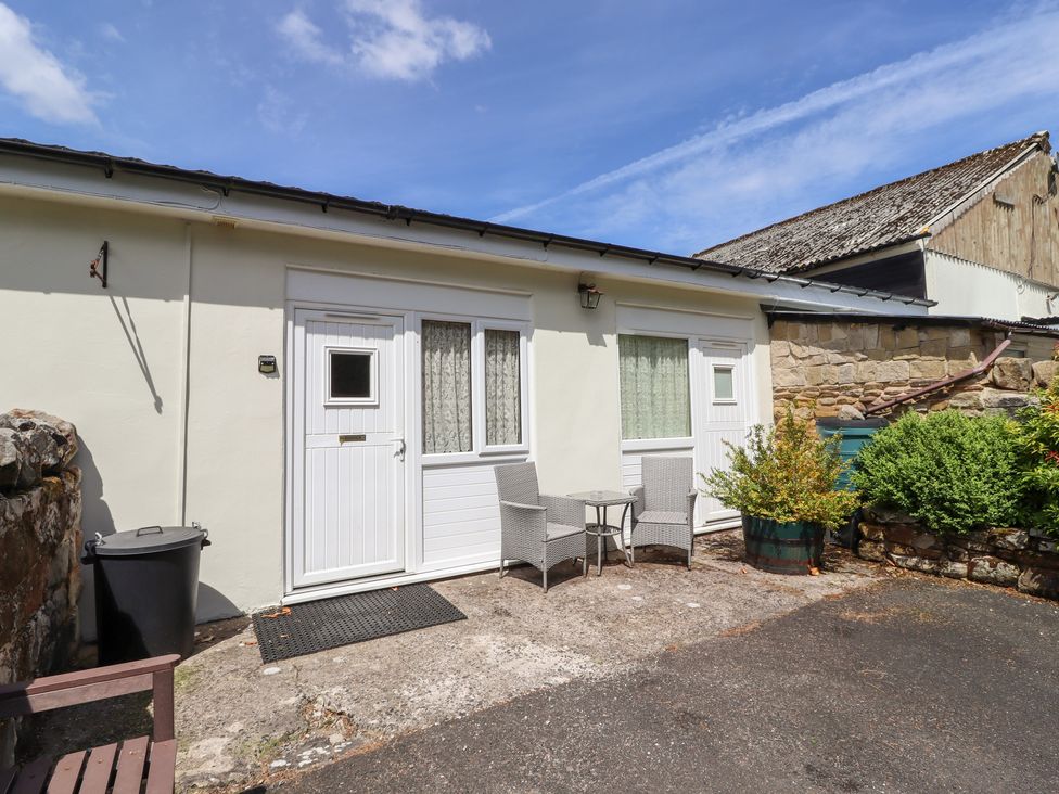 An outdoor area with chairs and a table at Stable Cottage Cottonshopeburnfoot near Otterburn